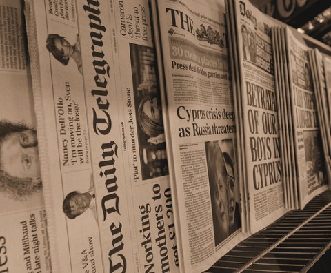 newspaper stand showing headlines and titles 